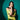 Mari Mari Woman in a green dress posing against a teal background